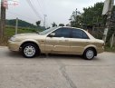 Ford Laser Delu 1.6 MT 2001 - Cần bán gấp Ford Laser MT đời 2001, màu vàng xe gia đình