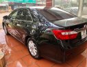 Toyota Camry 2.0E 2014 - Cần bán lại xe Toyota Camry 2.0E đời 2014, màu đen số tự động, giá 710tr