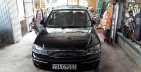 Ford Laser Ghia 1.8 AT 2005 - Bán Ford Laser Ghia 1.8 AT 2005, màu đen số tự động giá 260 triệu tại Quảng Bình